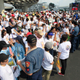Members of the Philippine National Police (PNP) stand guard in front of well-wishers waiting along a main street for the arrival of Pope Francis in Manila